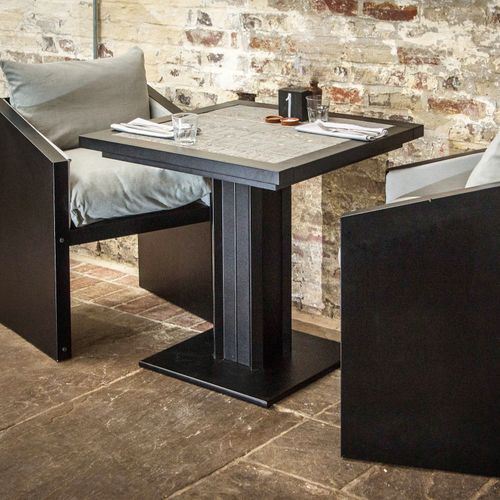 Workplace Large Bistro Table with accompanying chairs Ironfire grey bistro table with black frame in a cafe