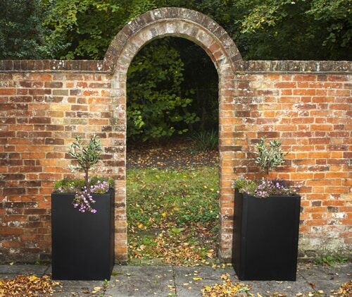 Planters by Brick Arch Autumn Planters with Flowers by Brick Wall